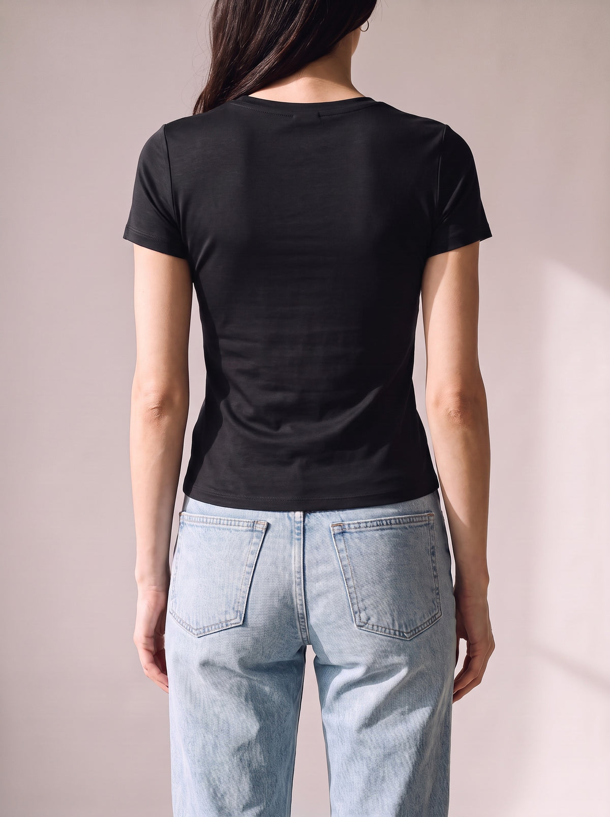 Worn by a woman: Her Baby Tee (Tencel), from the back