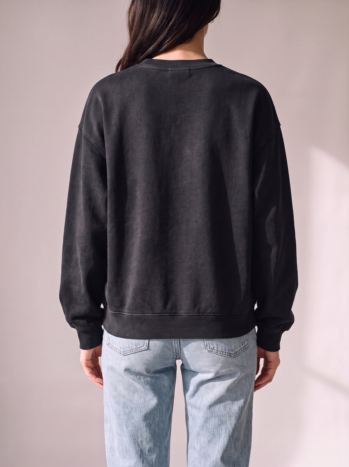 Worn by a woman: Crewneck Sweater, from the back