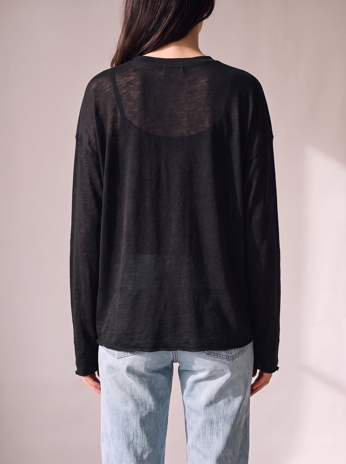 Worn by a woman: Her Sheer Long Sleeve, from the back