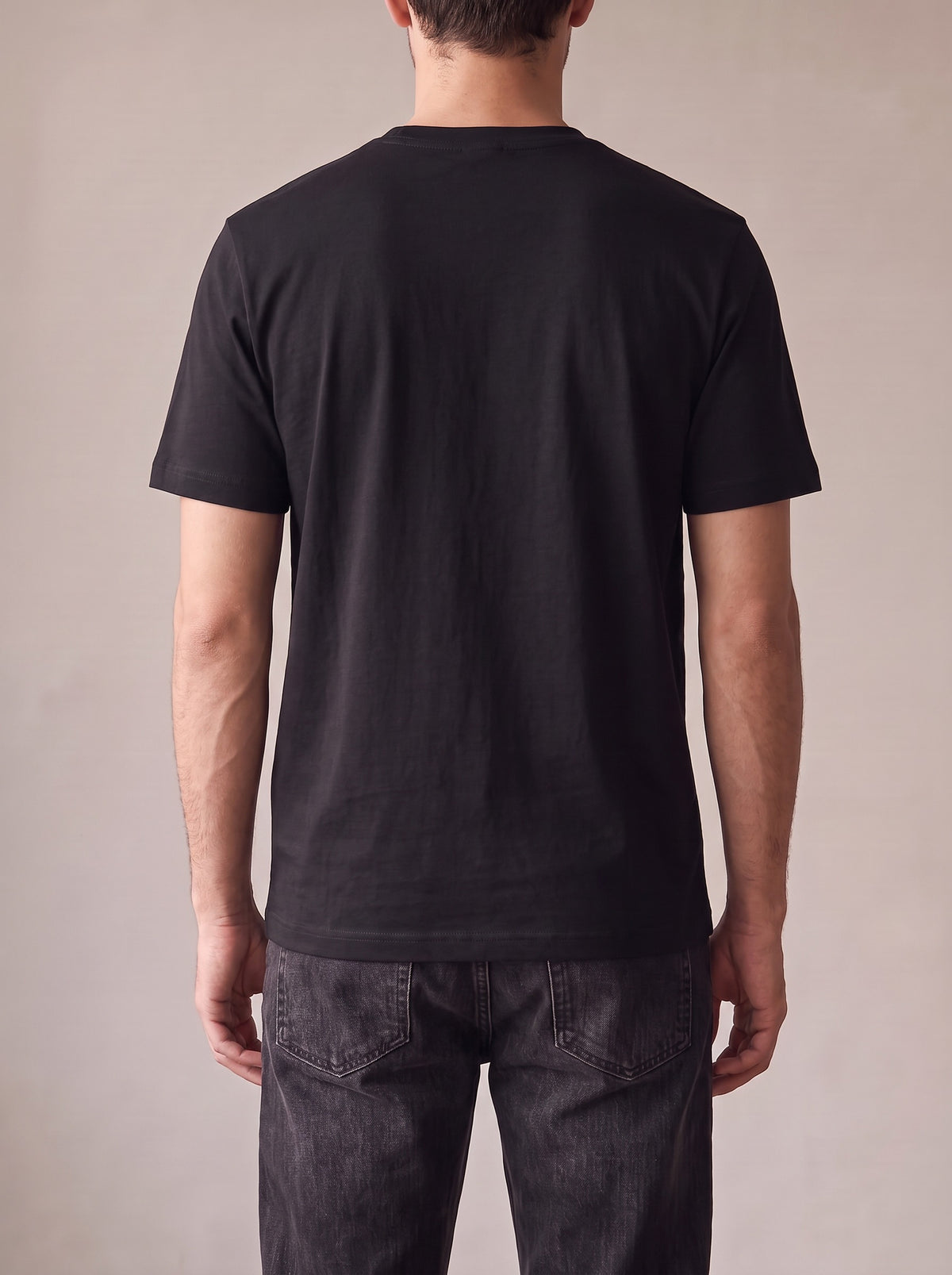 Worn by a man: His Tee, from the back