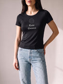 Worn by a woman: Her Baby Tee (Tencel), Cave Sorores on a black fitted Tencel baby tee with light blue jeans