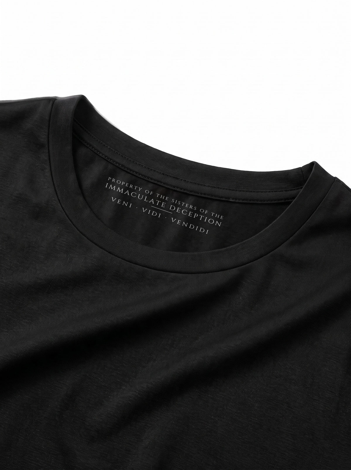 Worn by a woman: Her Baby Tee (Tencel), inside the collar: PROPERTY OF THE SISTERS OF THE IMMACULATE DECEPTION, VENI VIDI VENDIDI
