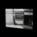 Annulments at full length as a glossy aluminum print floating off a black wall, with the board added for the website; the print ships uncensored
