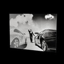 Two Cars as a glossy aluminum print floating off a black wall, turning so the light moves across the metal
